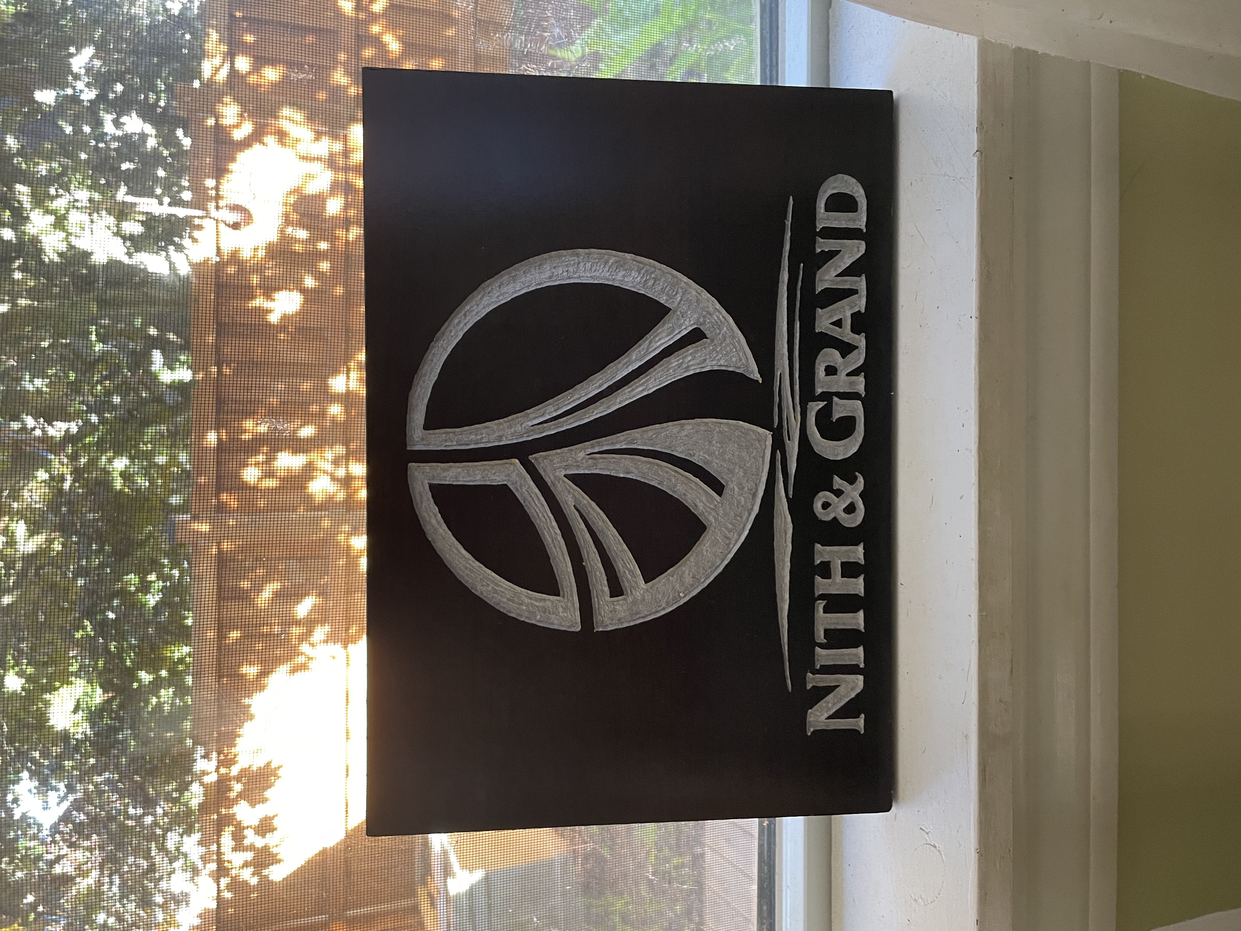 Nith & Grand hand-carved black sign