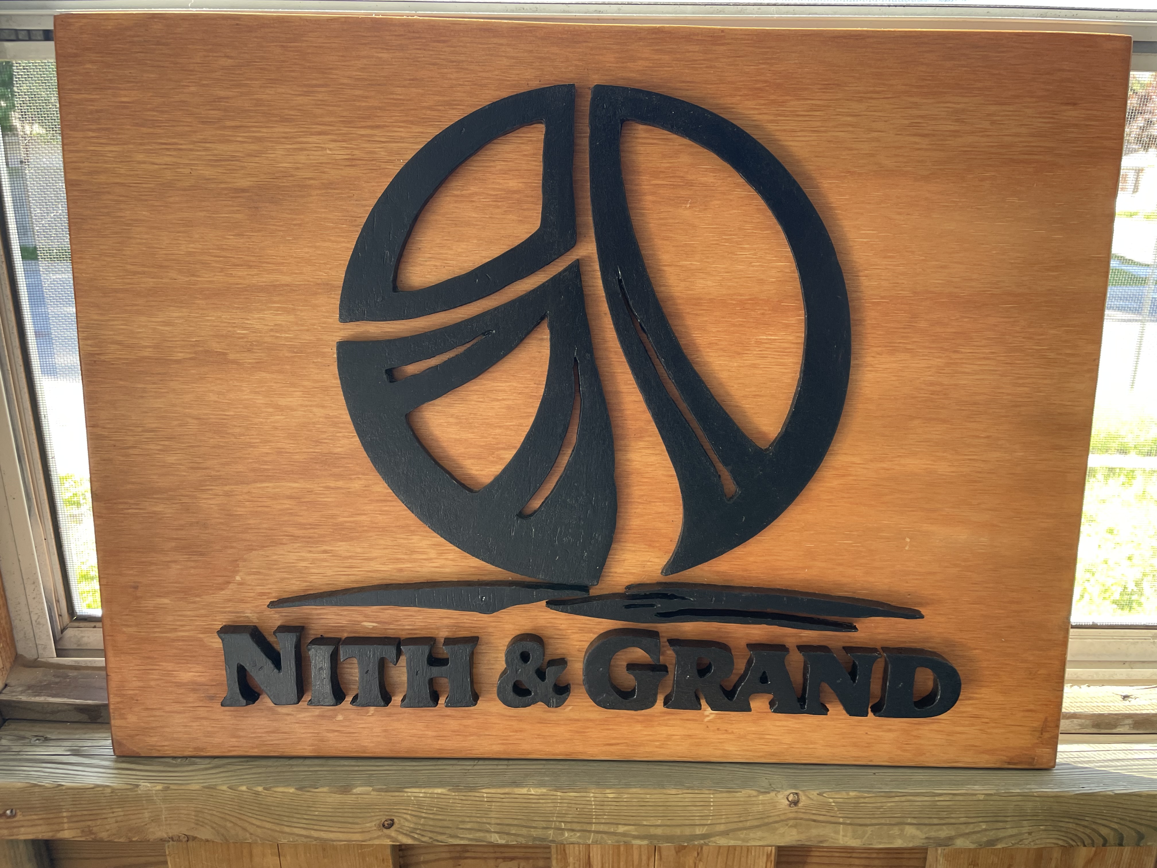 Hand-carved wood Nith & Grand sign