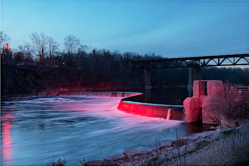 The dam lit red over the river